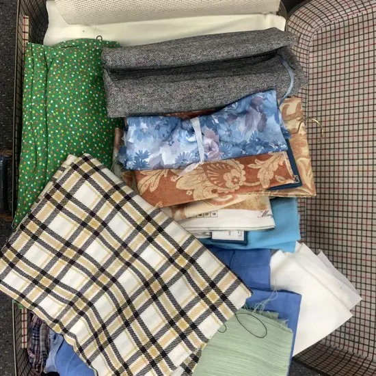 Blue Suitcase With Assorted Fabric Pieces