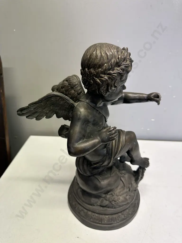Spelter Sculpture Depicting A Winged Cupid Sitting On A Rock H33cm. Image 1++