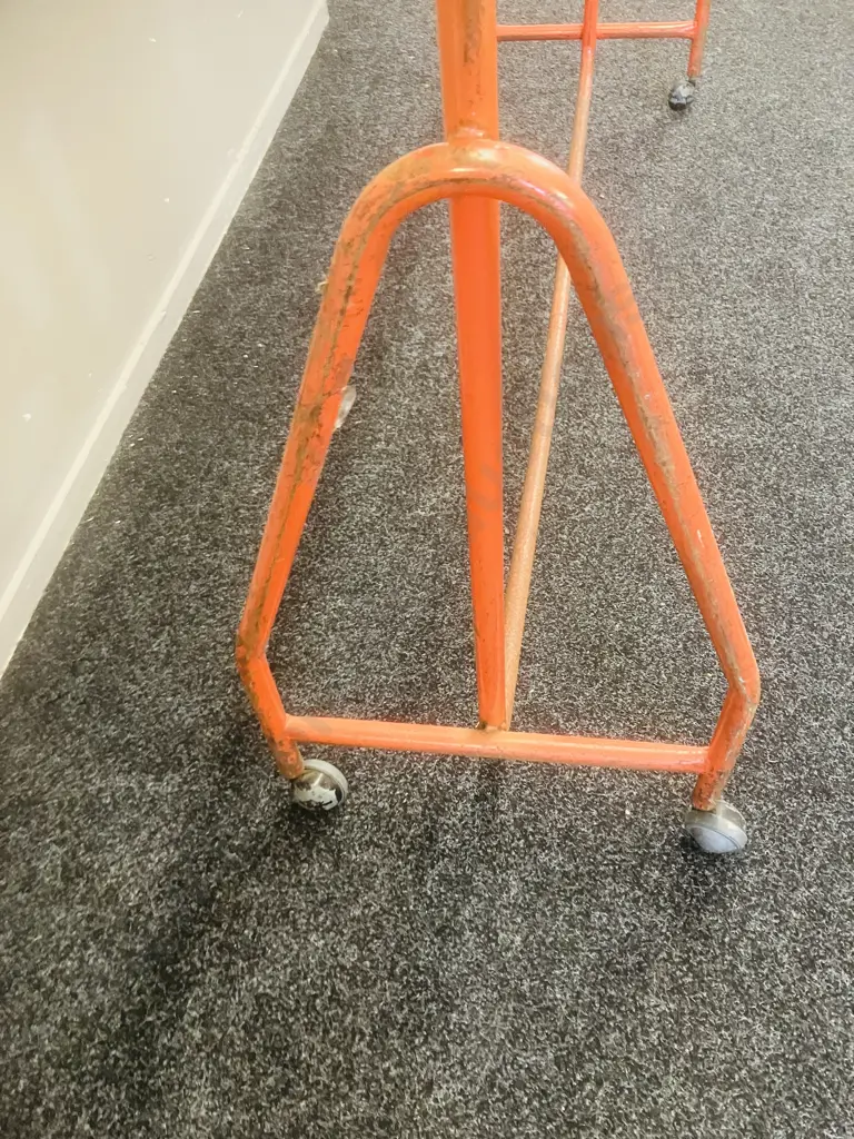 Steel Single Rail Garment Rack Painted Orange With Chrome Top Rail, On Castors (1 Wheel Damaged). H153 W157 D44cm Image 1++