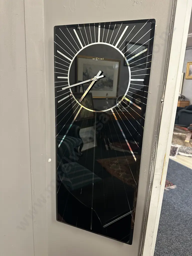 Modern Nextime Heavenly Wall Clock Black Glass With Silver Coloured Detail H70,W30cm. Image 1++