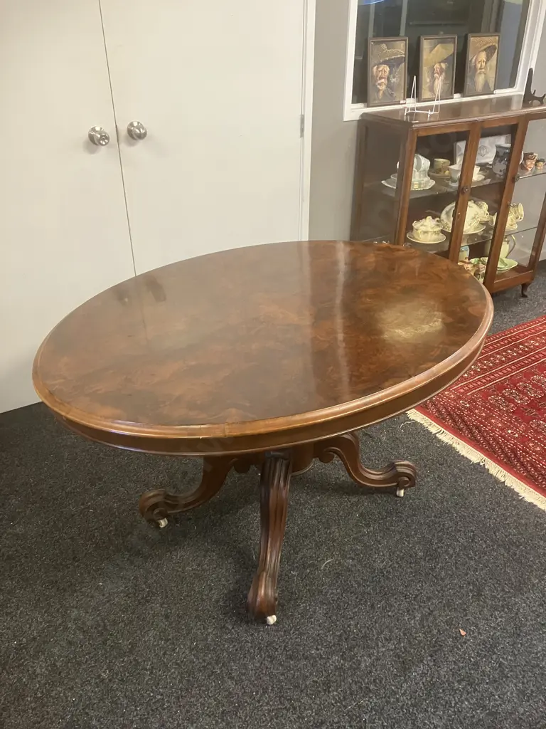Burr Walnut Victorian Oval Loo Table With Carved Base, White Porcelain Casters. H74 W133 D100cm Image 1++