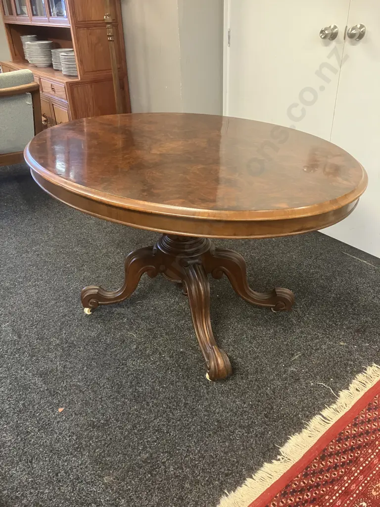 Burr Walnut Victorian Oval Loo Table With Carved Base, White Porcelain Casters. H74 W133 D100cm Image 1++