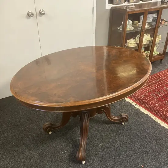 Burr Walnut Victorian Oval Loo Table With Carved Base, White Porcelain Casters. H74 W133 D100cm