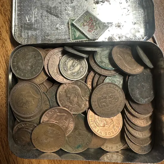 Collection Of Coins In Vintage Desert Tobacco Tin