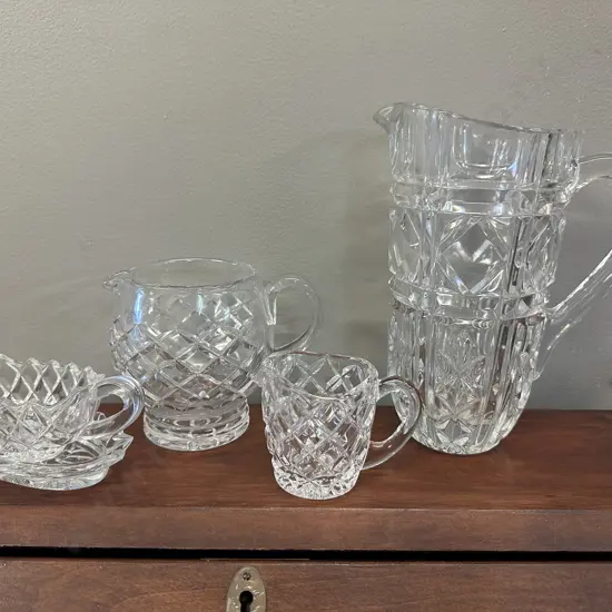 Selection Of Crystal Items Including Water Pitcher, Creamers Etc