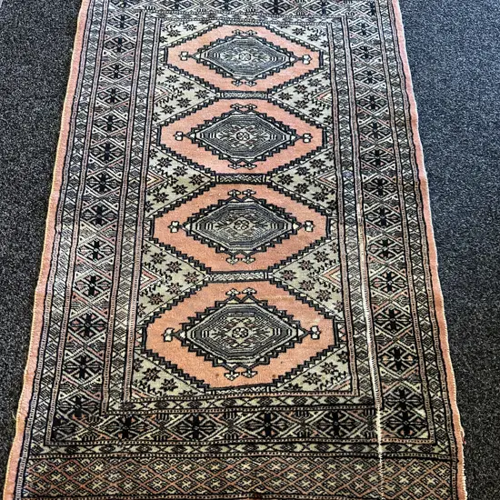 Vintage Hand Knotted Floor Rug With A Distinctive Salmon Pink Background Geometric Diamond & Medallion Motifs 122x76cm. 
