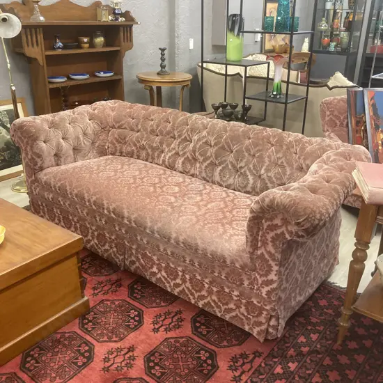Antique 3 Seater Couch. Original castors, plush pink pattern fabric. Button detail