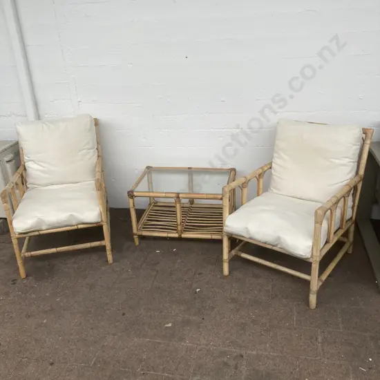 Cane Patio Suite. Two armchairs with cream fabric squabs and rectangular glass topped table - 67 x 47cm