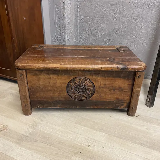 Vintage Solid Beaten Wood Chest. Lift up lid, leather straps. Carved central panel. H38 W79 D47cm