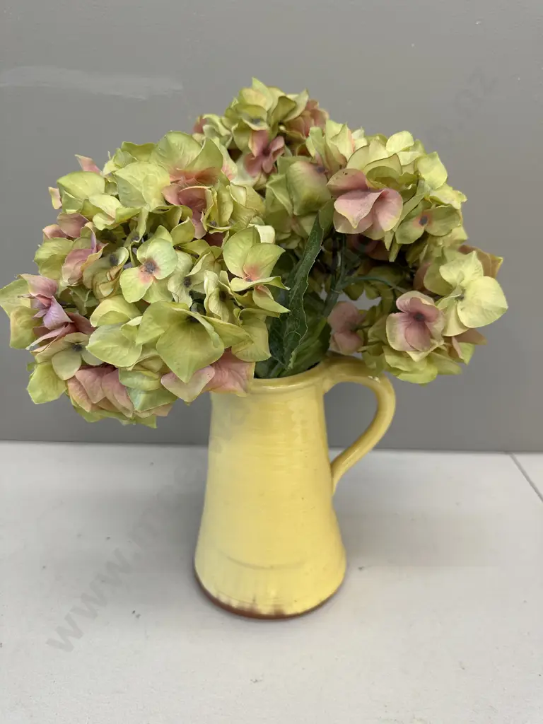 Faux Flowers In Decorative Yellow Jug Image 1++