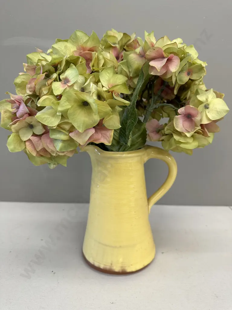 Faux Flowers In Decorative Yellow Jug Image 1++