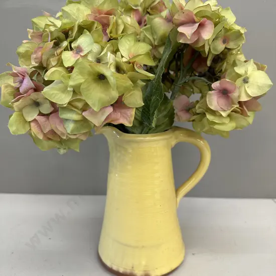 Faux Flowers In Decorative Yellow Jug