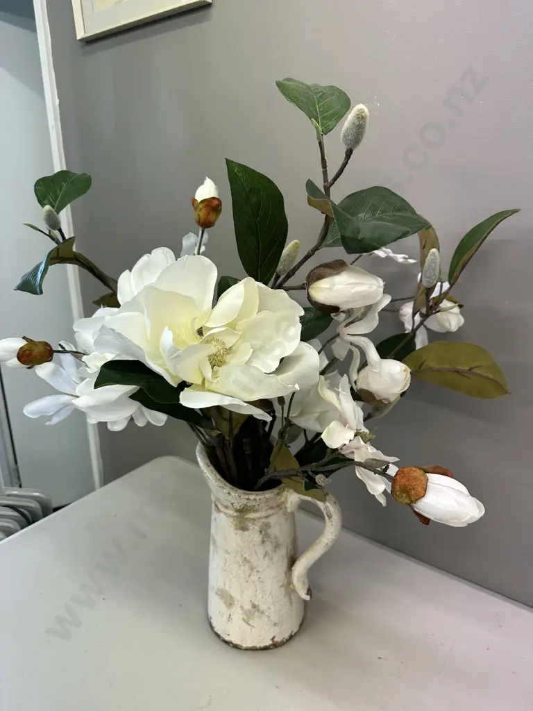 Faux Flowers In Decorative Jug Image 1++
