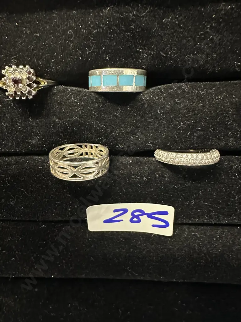 Assorted Rings On Black Display Stand Image 1++