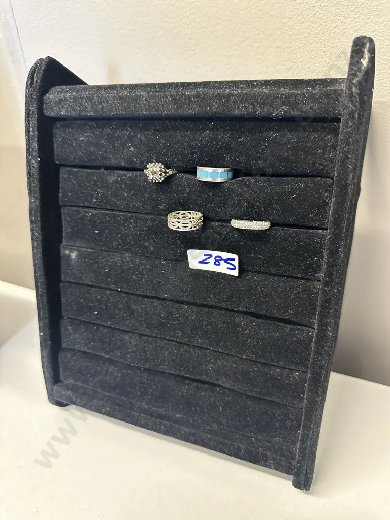Assorted Rings On Black Display Stand Image 1++
