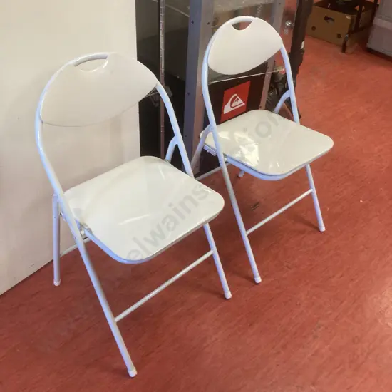 Pair of White Folding Chairs (One has small split on Seat)