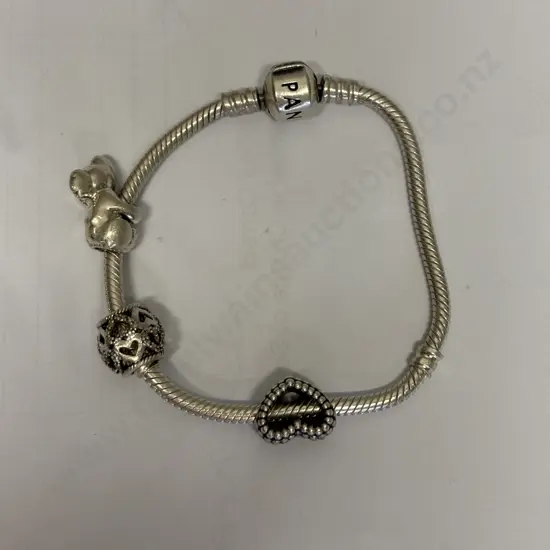 Sterling Silver Pandora Bracelet with 3 charms. Stamped 925