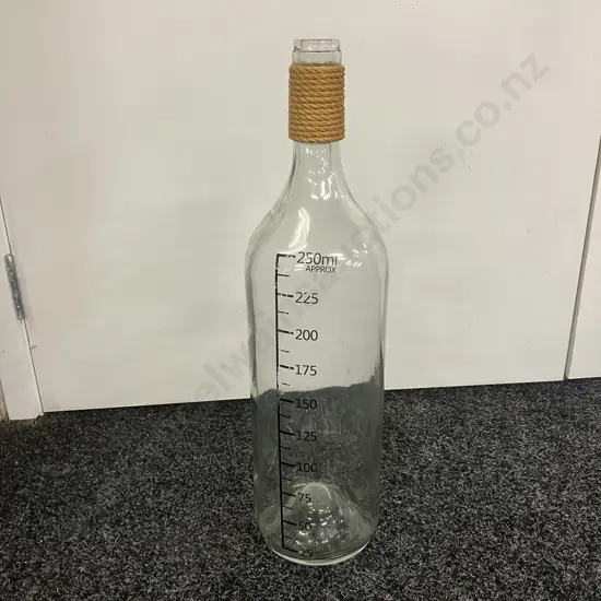 Large Glass Bottle With Raffia Around The Neck. 54 x 14cm