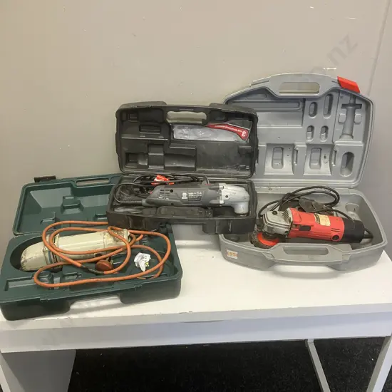 Three Angle Grinders In Plastic Cases