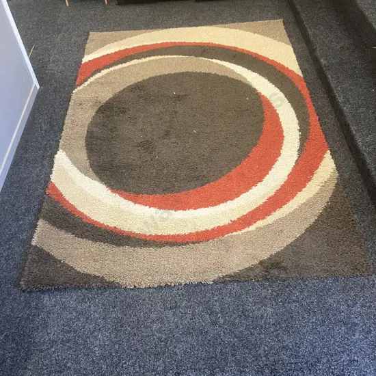 Milano Floor Rug With a Brown / Tan / Cream / Red Circular Pattern. 158 x 228