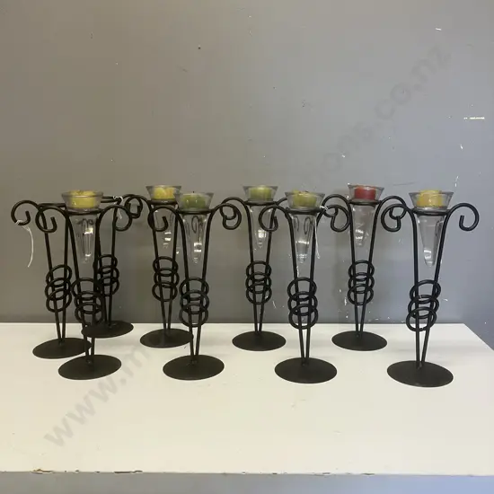 Seven Black Metal & Glass Candle Holders With Candles & Two Without Glass / Candles. H28cm