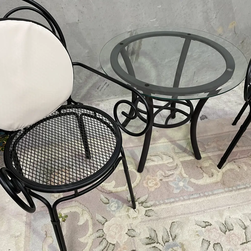 3 Piece Outdoor/Indoor Set. Glass top table with metal frame. Black metal framed chairs, excellent condition Image 1++