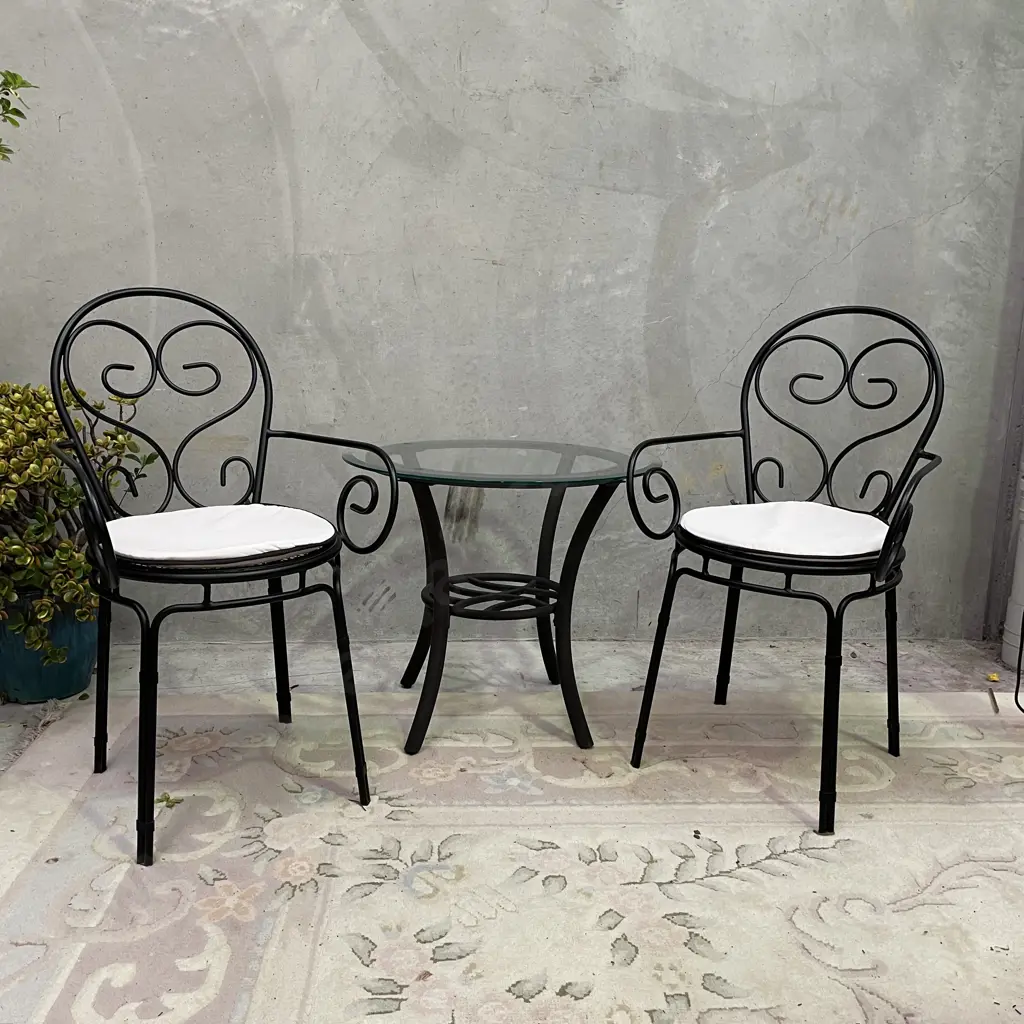3 Piece Outdoor/Indoor Set. Glass top table with metal frame. Black metal framed chairs, excellent condition Image 1++