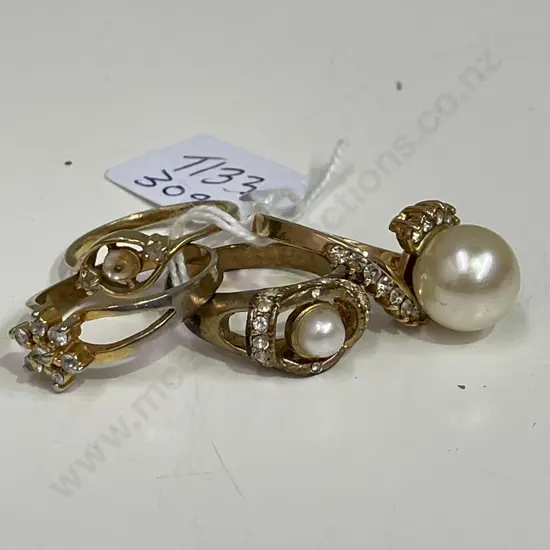 Four gold coloured rings with assorted stones. Some stamped