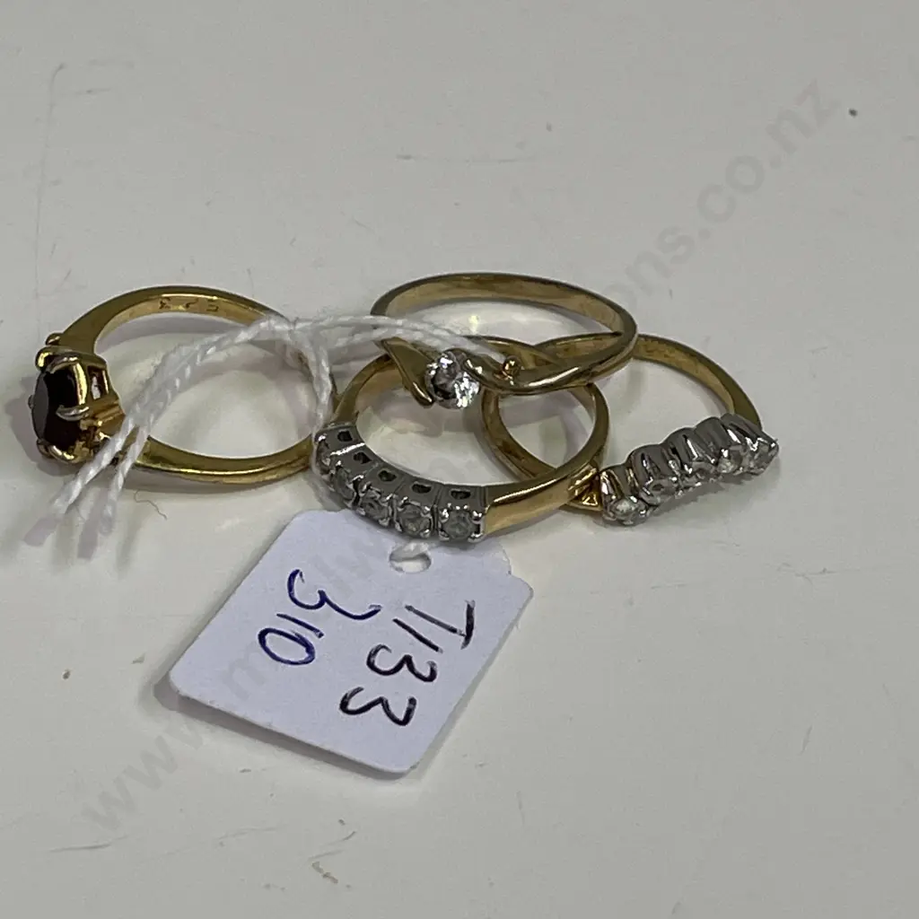 Four gold coloured rings with assorted stones. Some stamped Image 1++