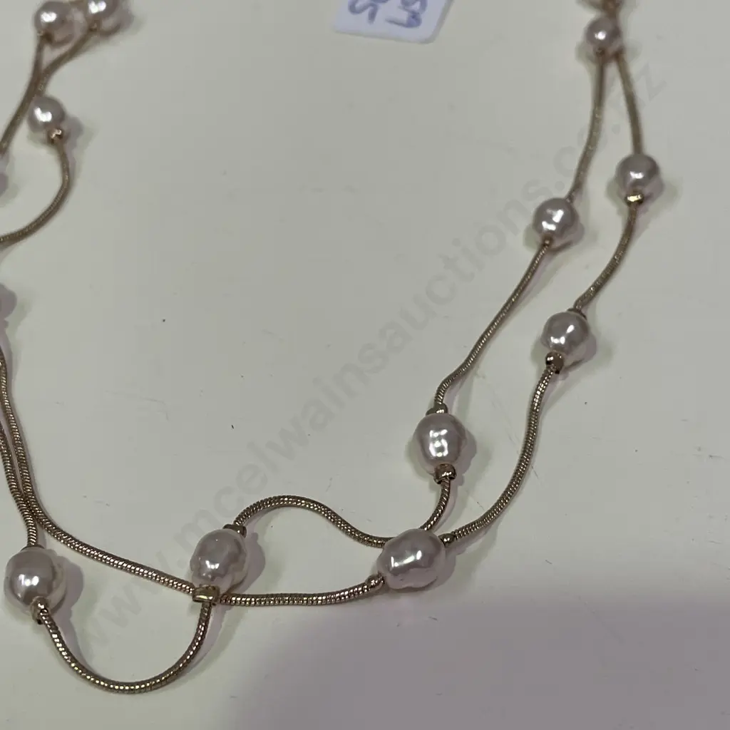 Rose gold coloured necklace with intersecting pearl type beads Image 1++