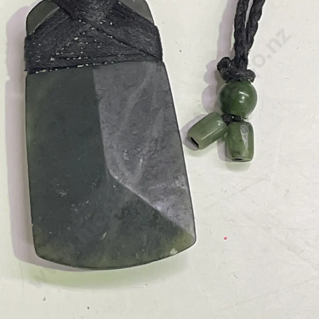 Greenstone Pounamu with rope necklace and greenstone tie ends. Image 1++