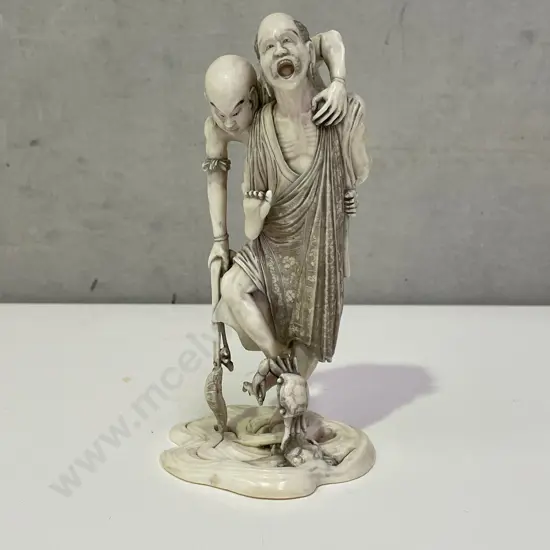 Intricately Carved Fine Ivory Okimono. Rakkan attempting to pull a Kappa from the Sea. H18cm. Base claw is detached.