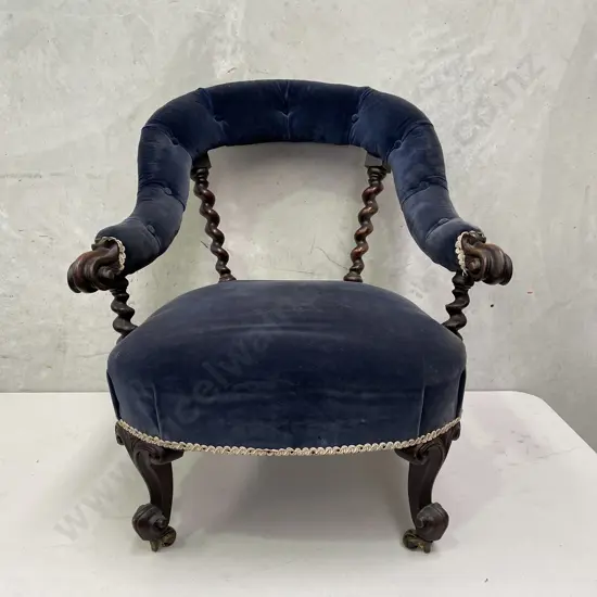 Antique Tub Chair. Carved barley twist pillar back, buttoned royal blue velvet fabric. Original castors