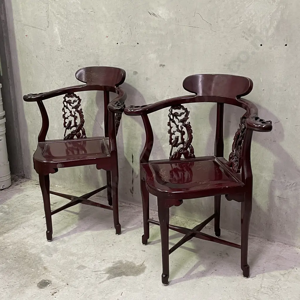 Pair of Vintage Chinese Rosewood Armchairs. Cross base with oval high back plate and intricately carved panels and arms. Image 1++