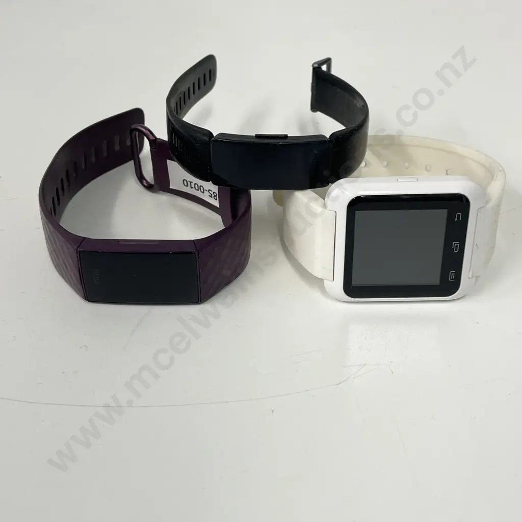 Purple Fitbit Watch with two other watches Image 1++