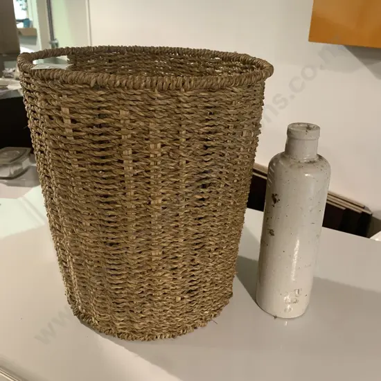 Woven wastepaper basket with vintage stoneware bottle