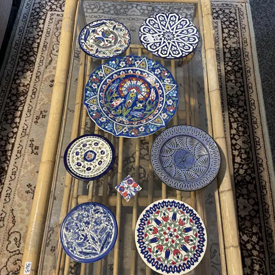 Selection of handpainted plates, some with enamelling. Various sizes
