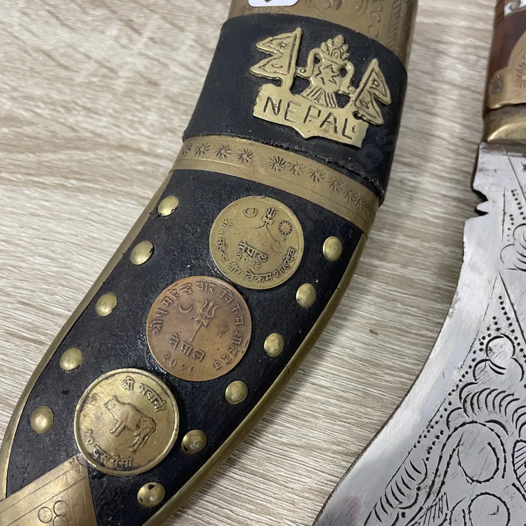 Knife and Scabbard with two miniature knives. Nepal. Ornately detailed with coins and brass. Etched blade Image 1++