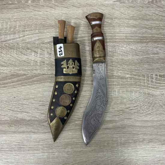 Knife and Scabbard with two miniature knives. Nepal. Ornately detailed with coins and brass. Etched blade