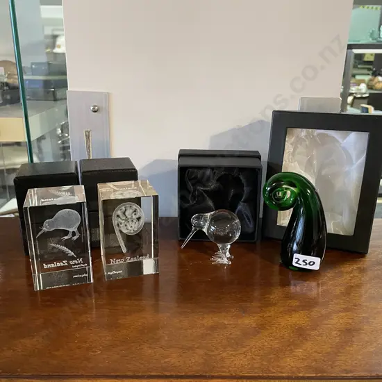 Four Art Glass Kiwiana items including paperwieghts, Kiwi and Koru