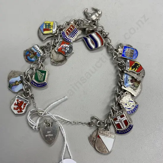 Sterling Silver Charm Bracelet with large assortment of Sterling Silver Shield and other charms 